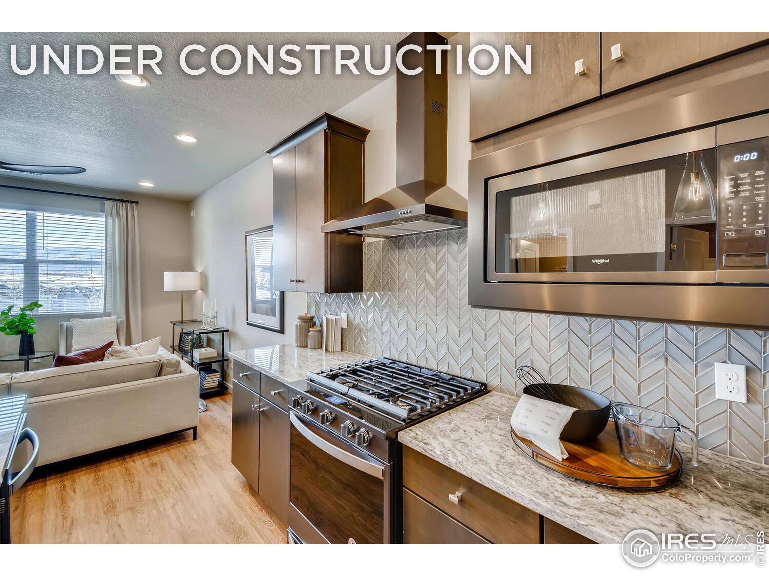 a kitchen with kitchen island granite countertop a stove and a sink