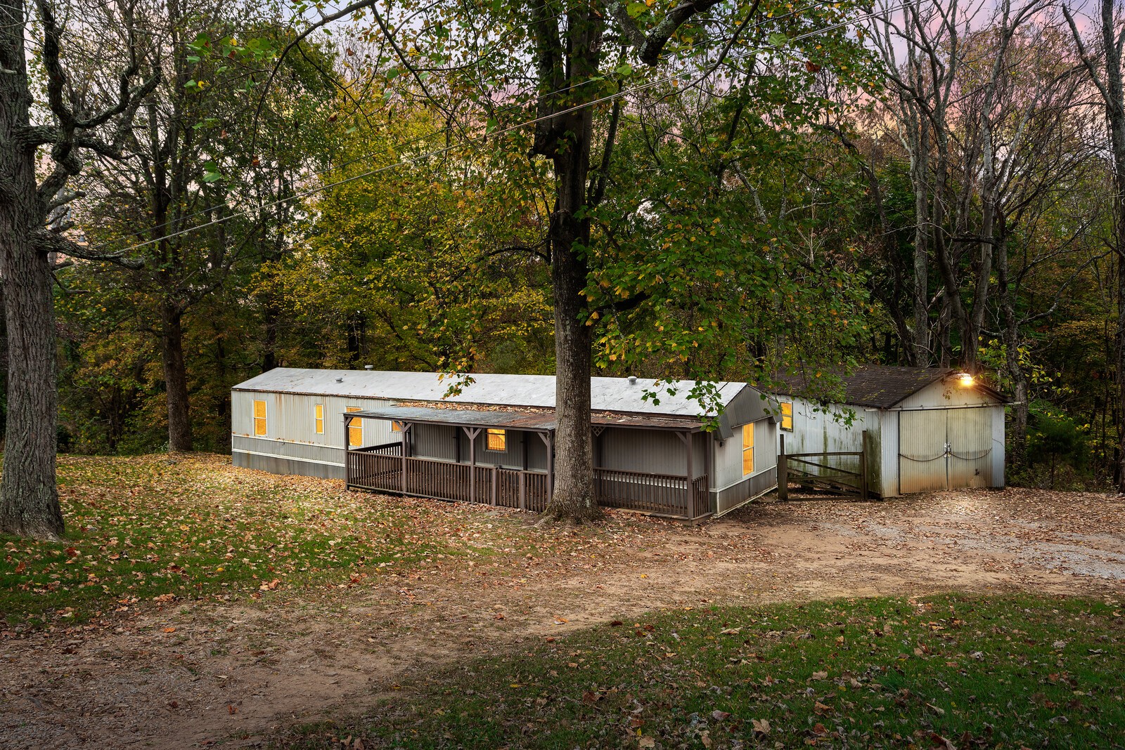 a view of a house with backyard and tree