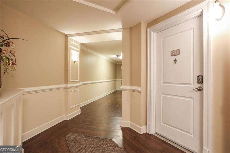 a view of empty room with wooden floor