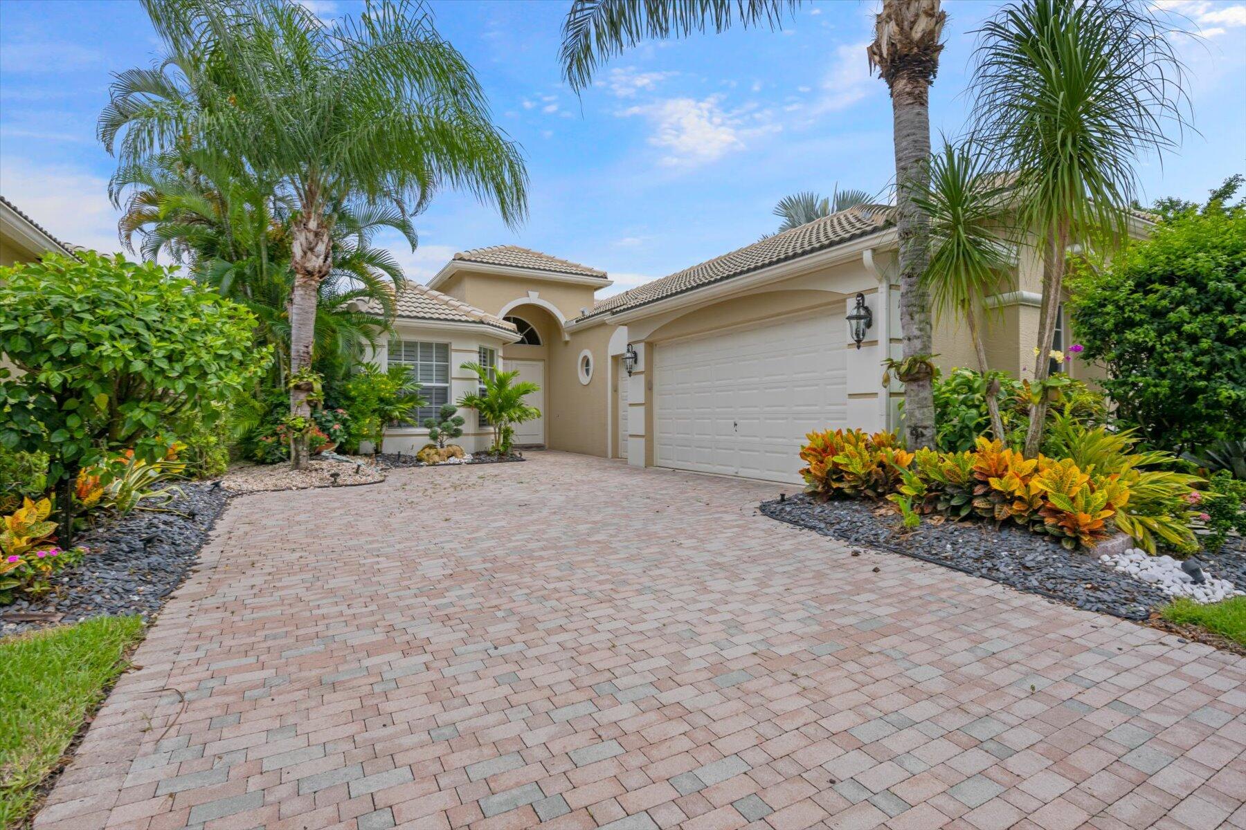 a front view of a house with a yard and a garage