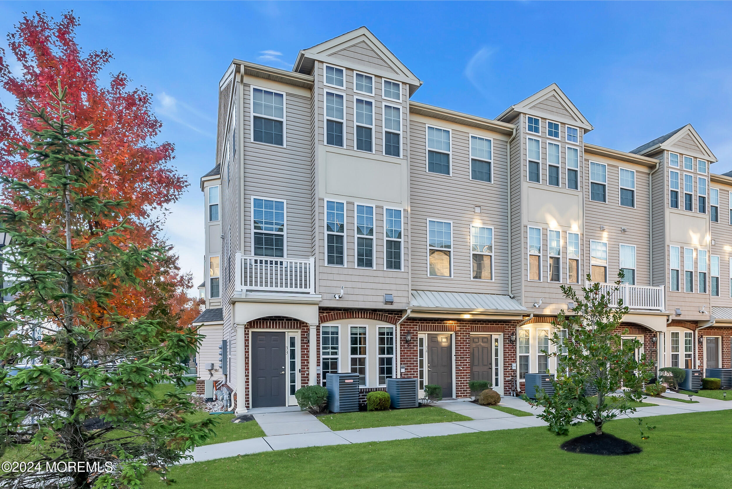 a front view of a residential apartment building with a yard