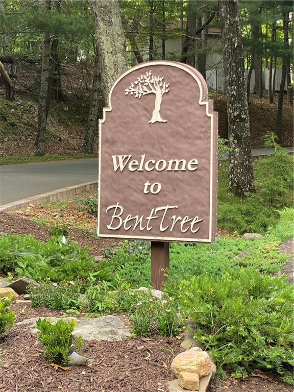 a view of sign board with yard and lake view