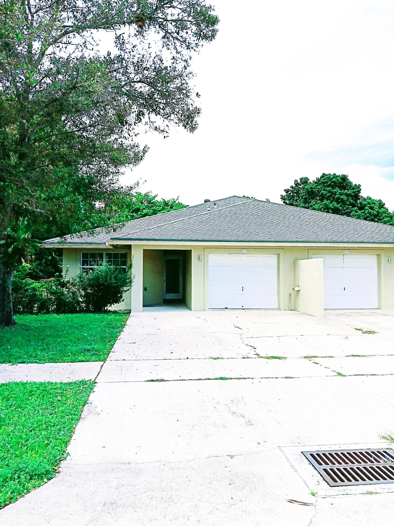 a front view of a house with a garden and yard