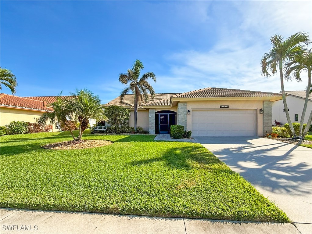 a front view of a house with a yard and garage