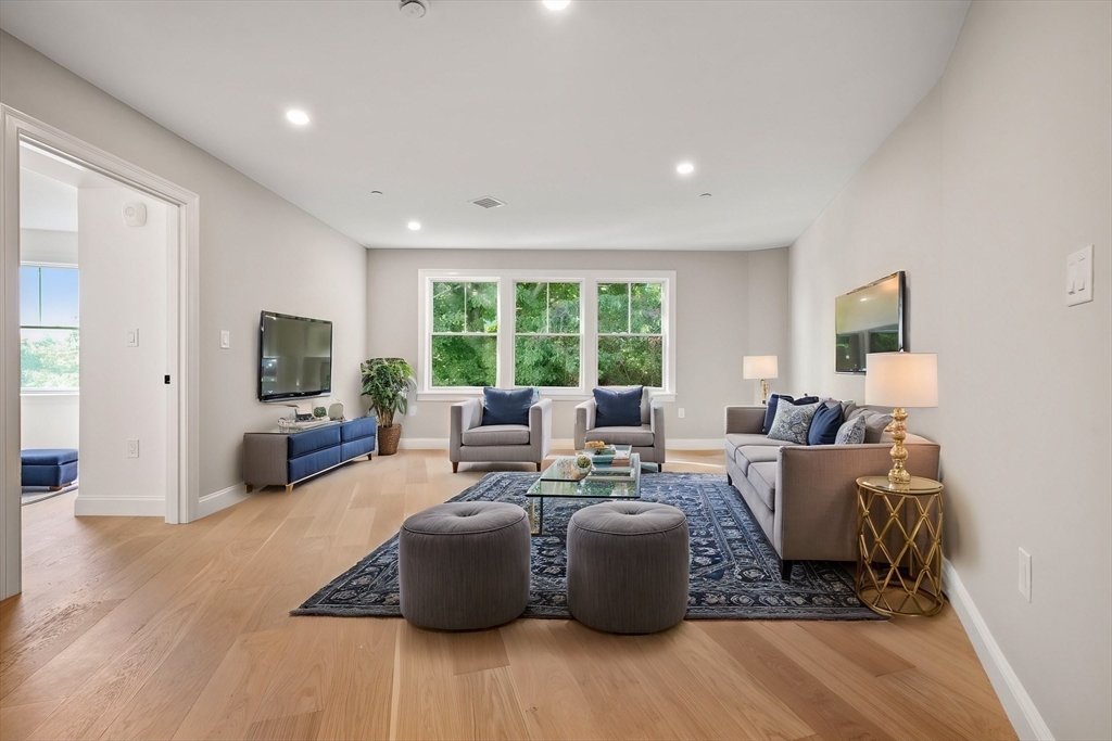 a living room with furniture large window and a fireplace