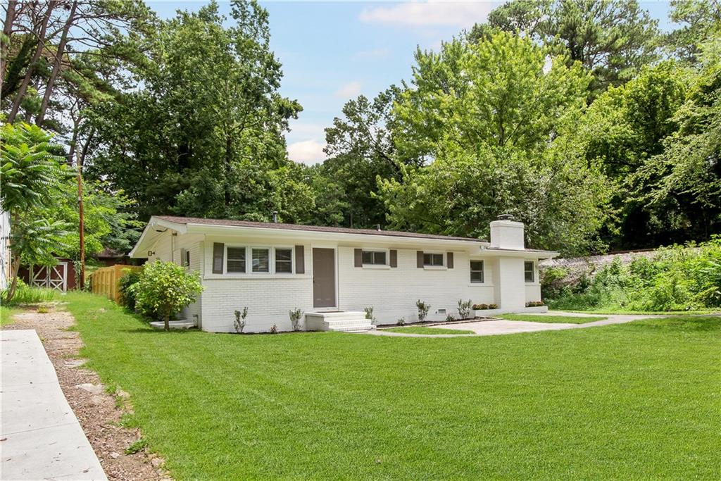 a front view of house with yard and green space