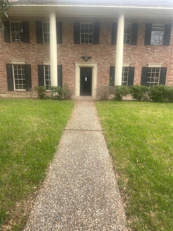 a front view of a house with a garden and yard