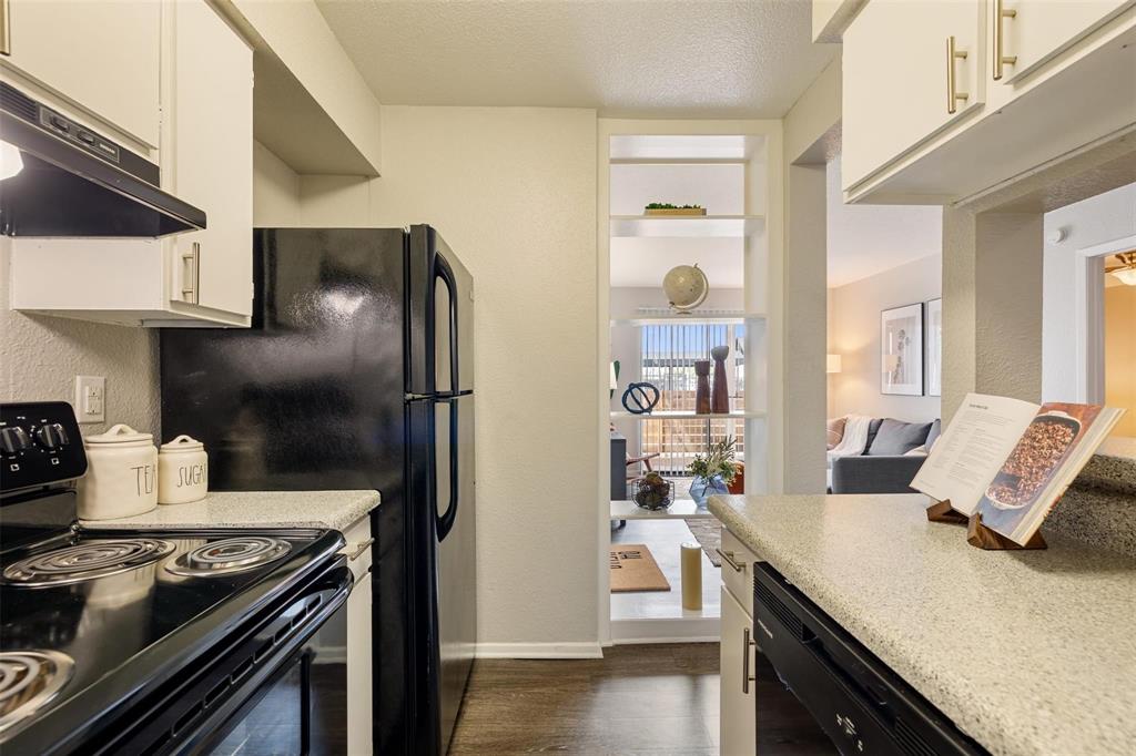 a kitchen with stainless steel appliances granite countertop a stove and a refrigerator