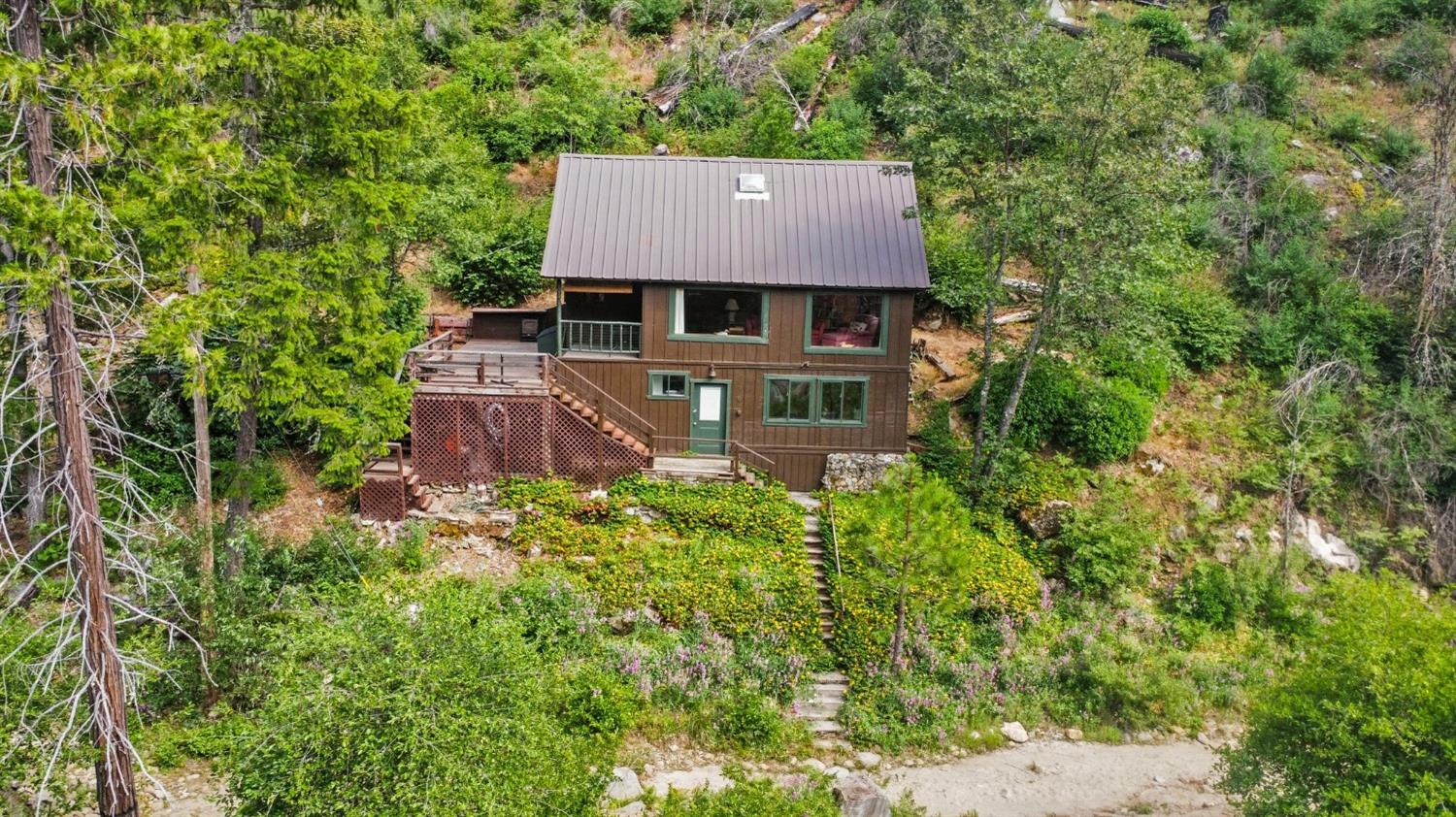 an aerial view of a house with a yard