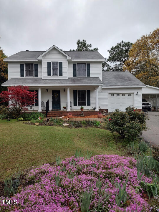 a front view of a house with garden