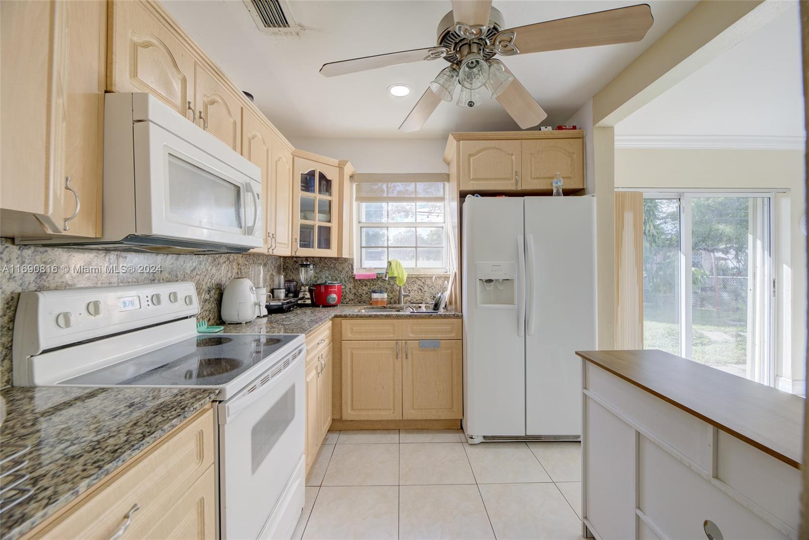 a kitchen with a refrigerator a sink and cabinets