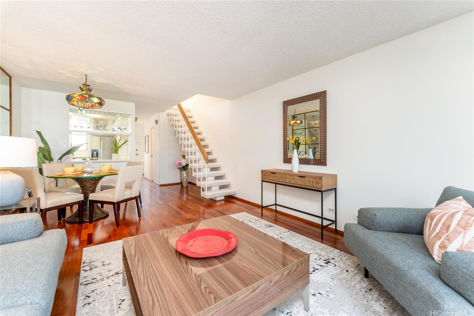 a living room with furniture and wooden floor