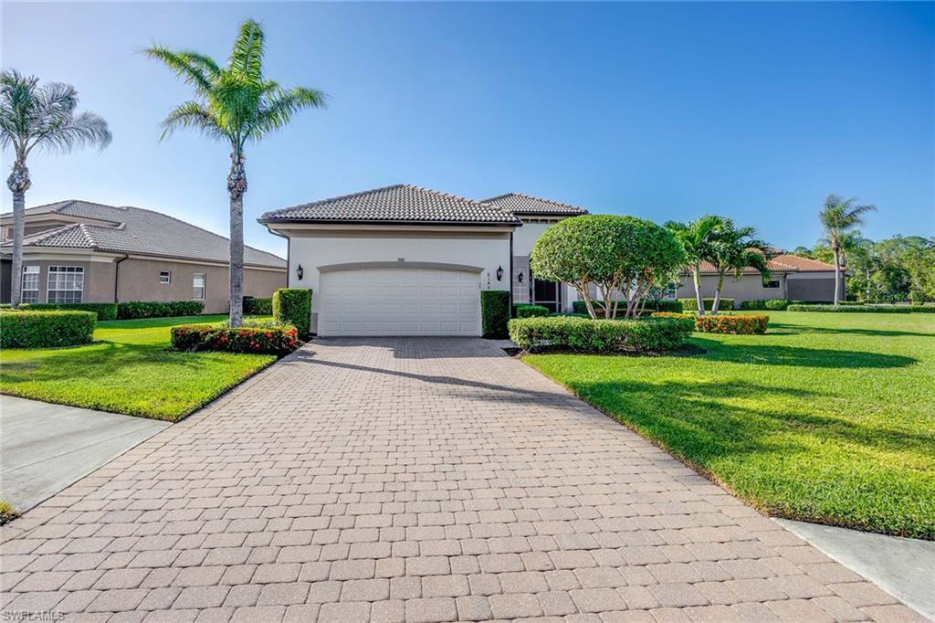 a front view of a house with a yard and garage