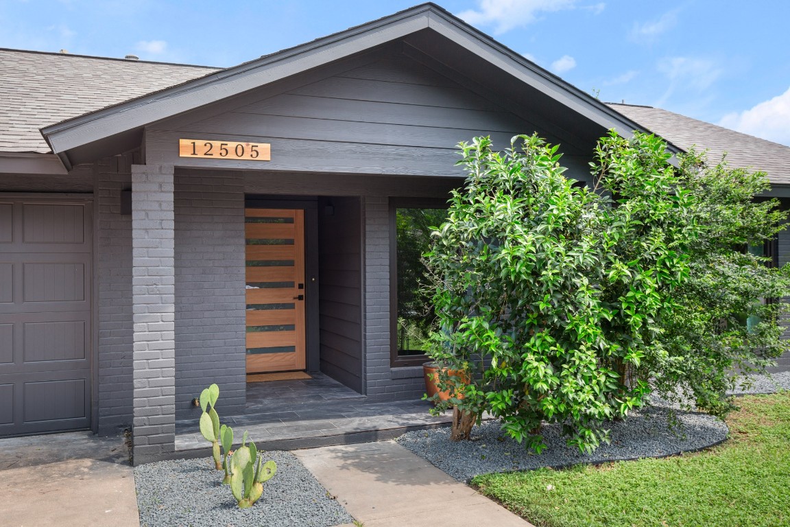 a front view of a house with garden