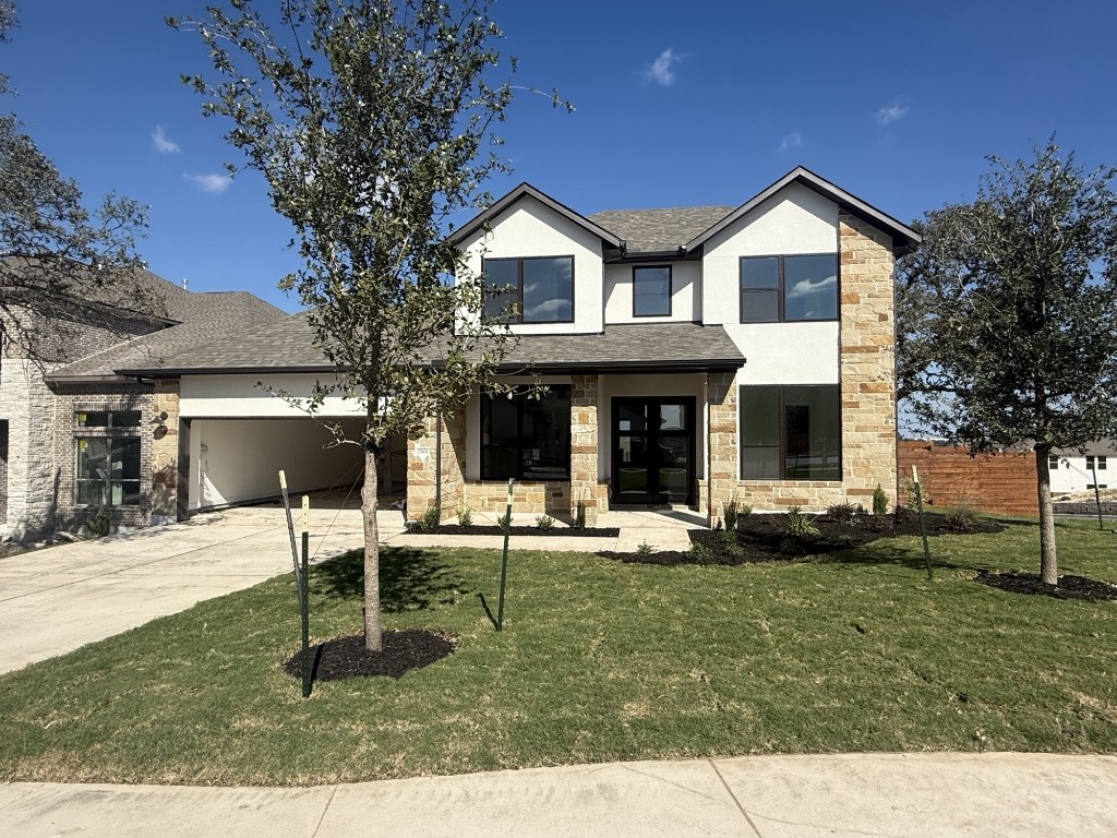 a view of a house with a yard and sitting area