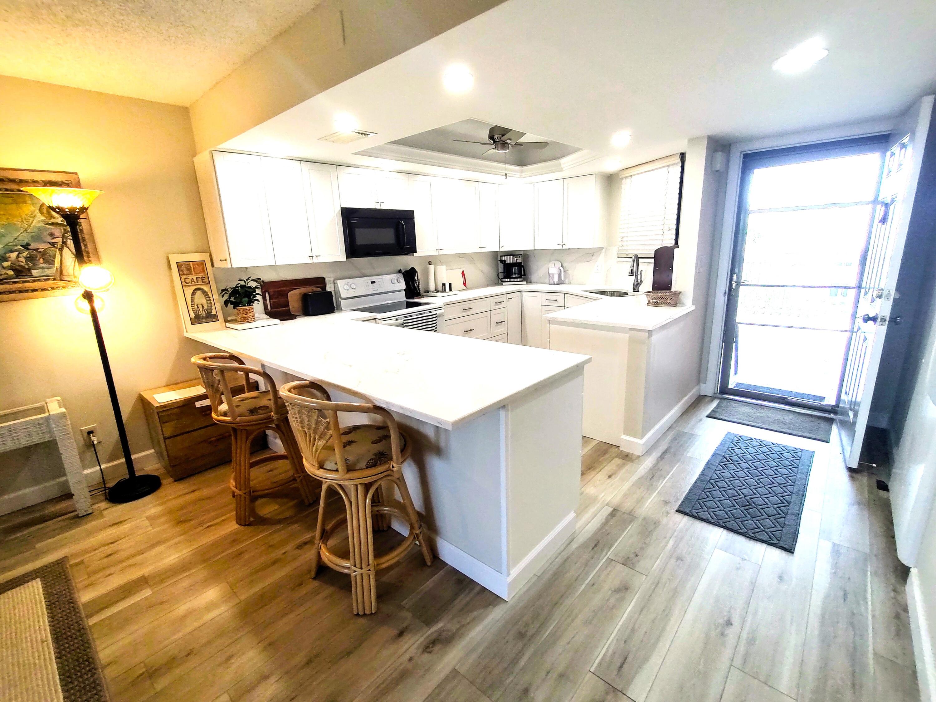 a large kitchen with a table and chairs