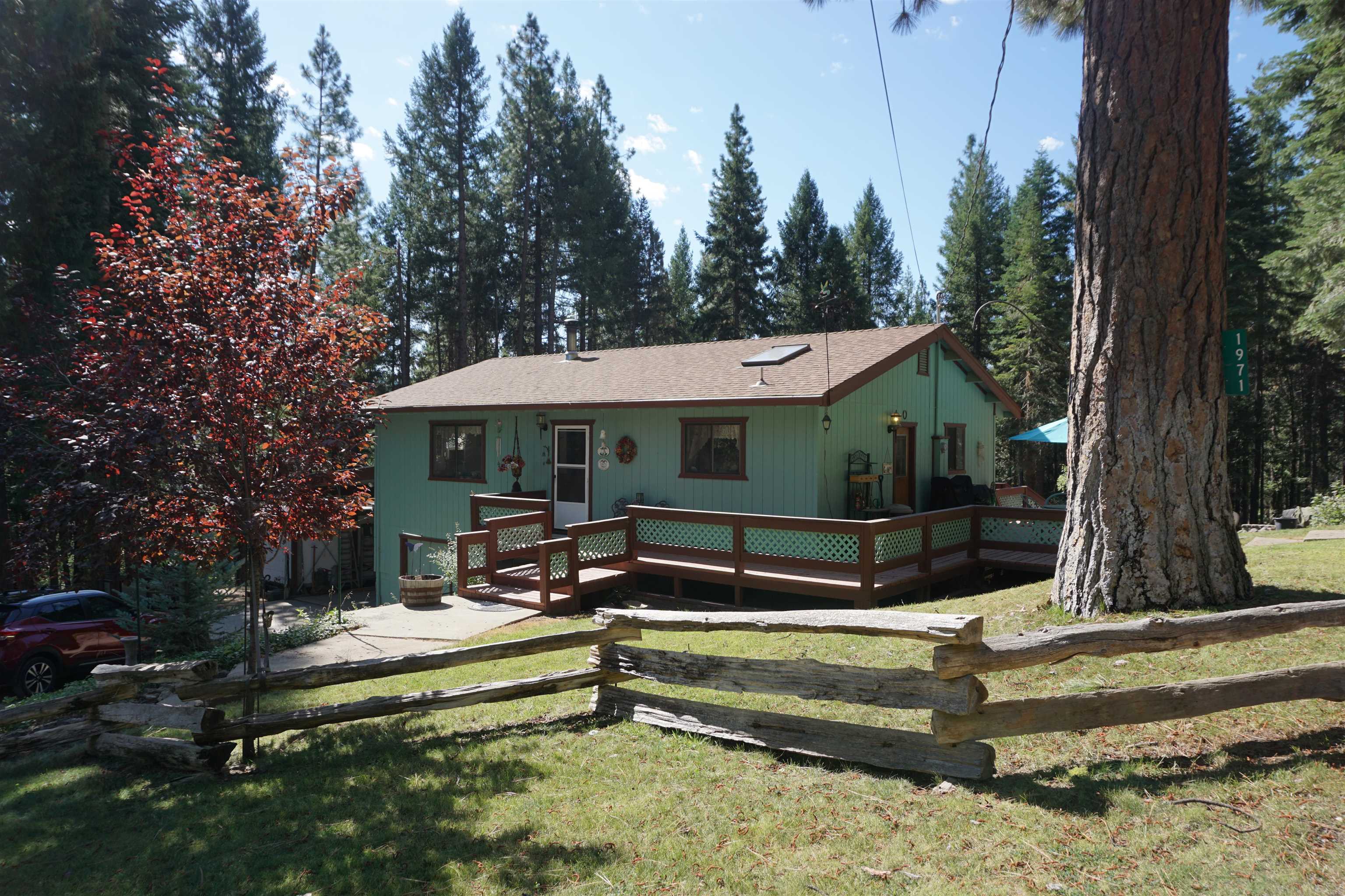 a view of house with swimming pool and sitting area