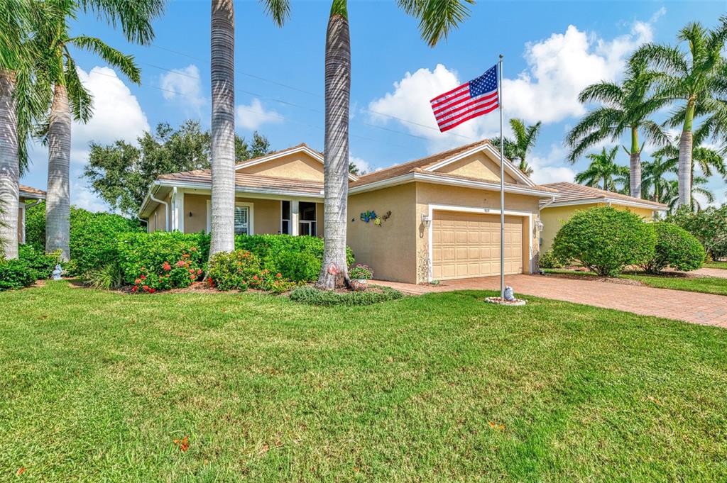 a front view of a house with a yard and garage