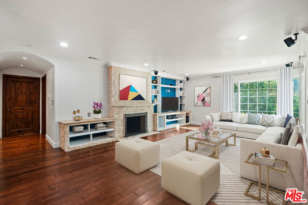 a living room with furniture fireplace and flat screen tv