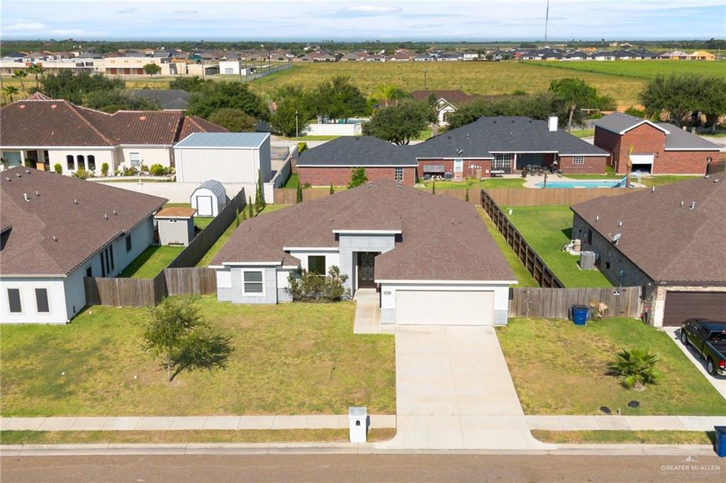 an aerial view of residential houses with outdoor space and ocean view