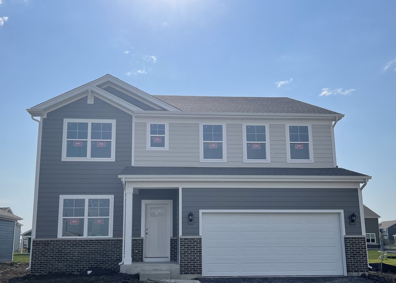 a front view of a house with garage