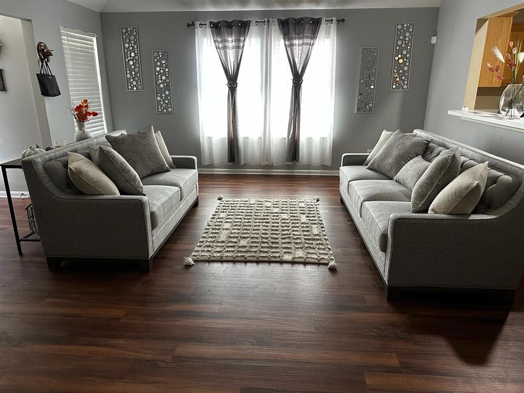 a living room with furniture and a rug