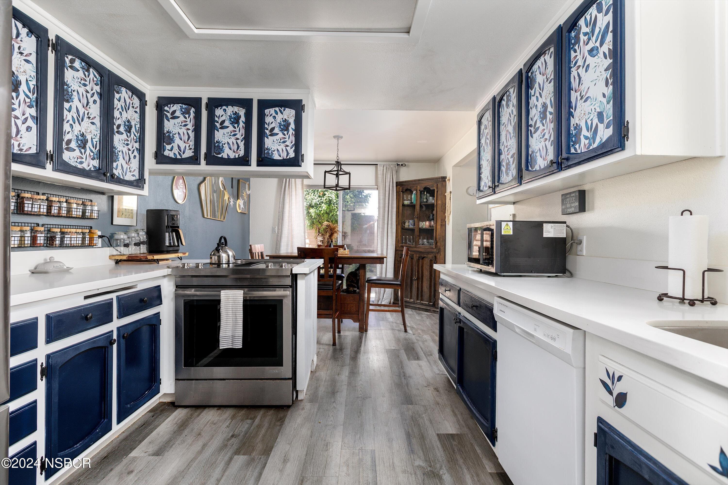 a kitchen with stainless steel appliances granite countertop a stove and cabinets