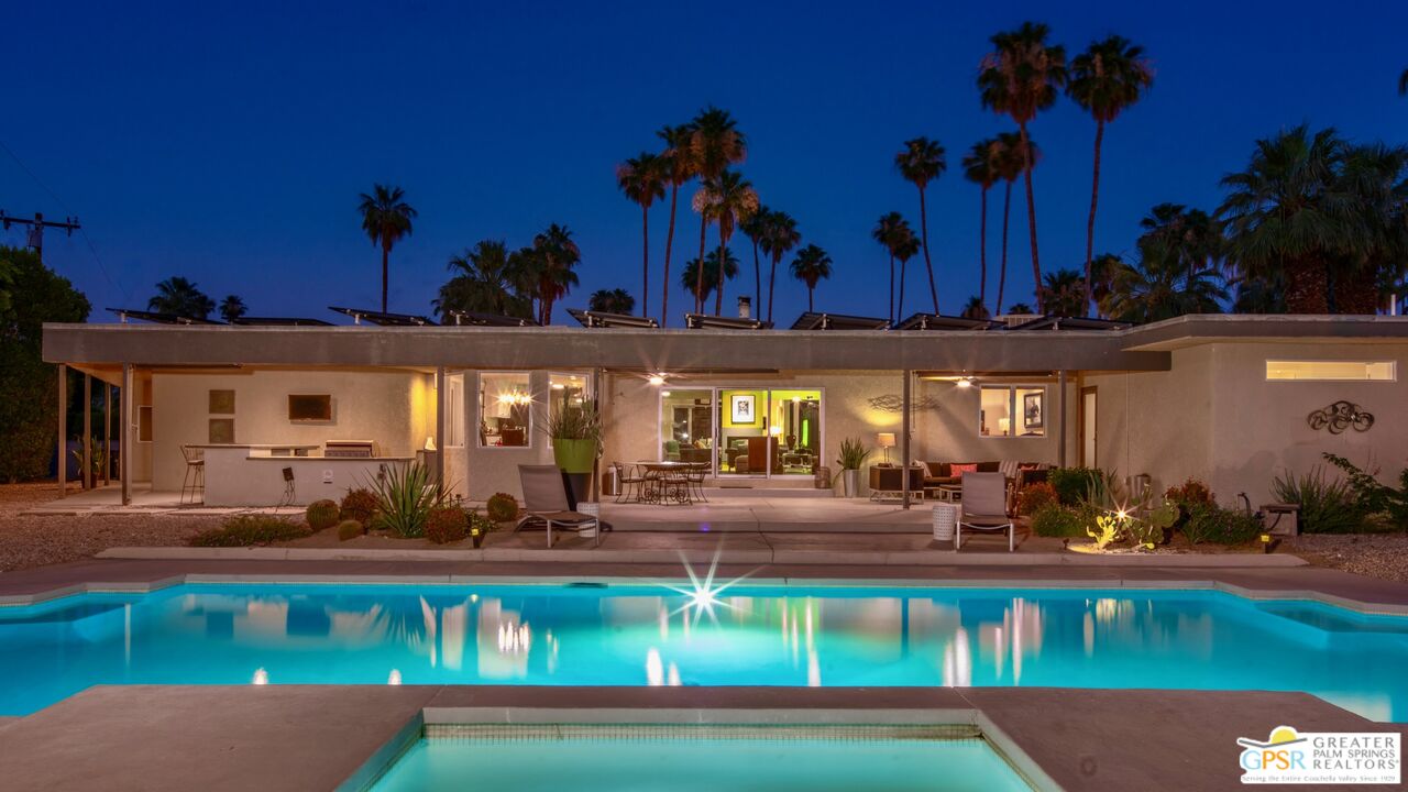 a view of a swimming pool with outdoor seating