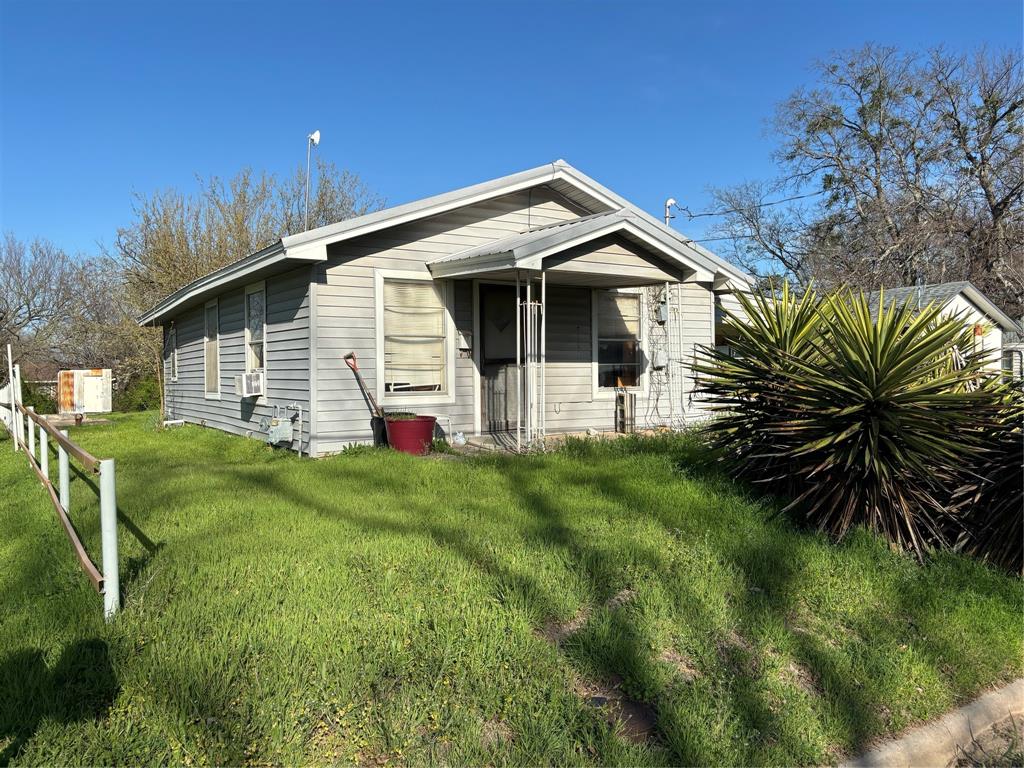 a front view of house with yard and green space