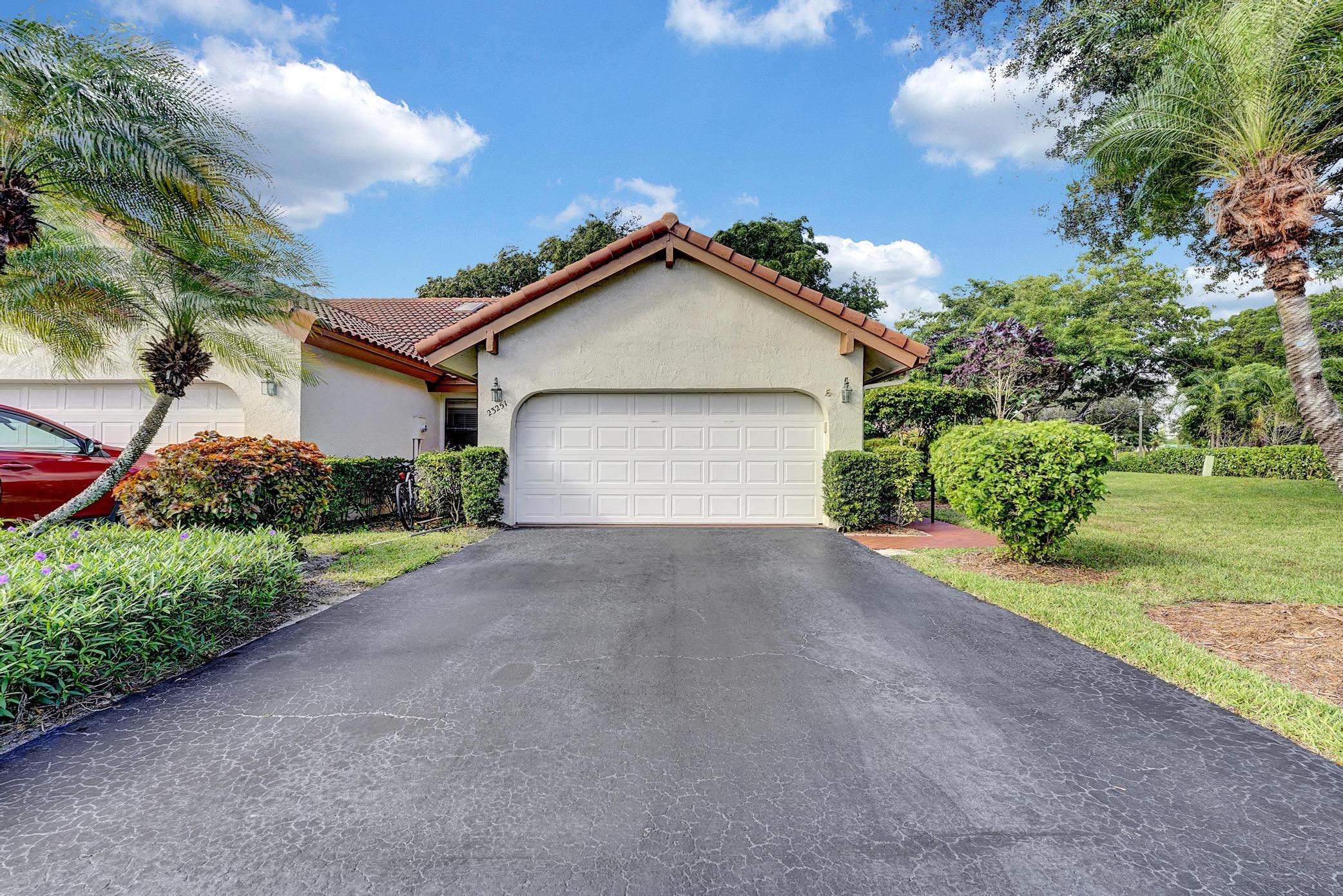 a view of a house with a yard and garage