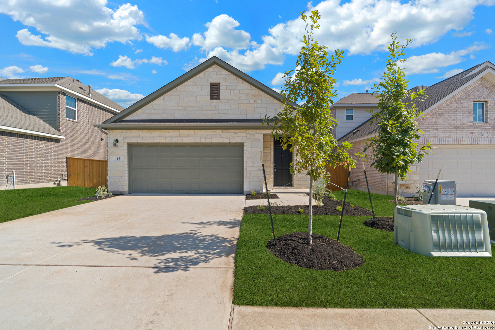 a front view of a house with a garden