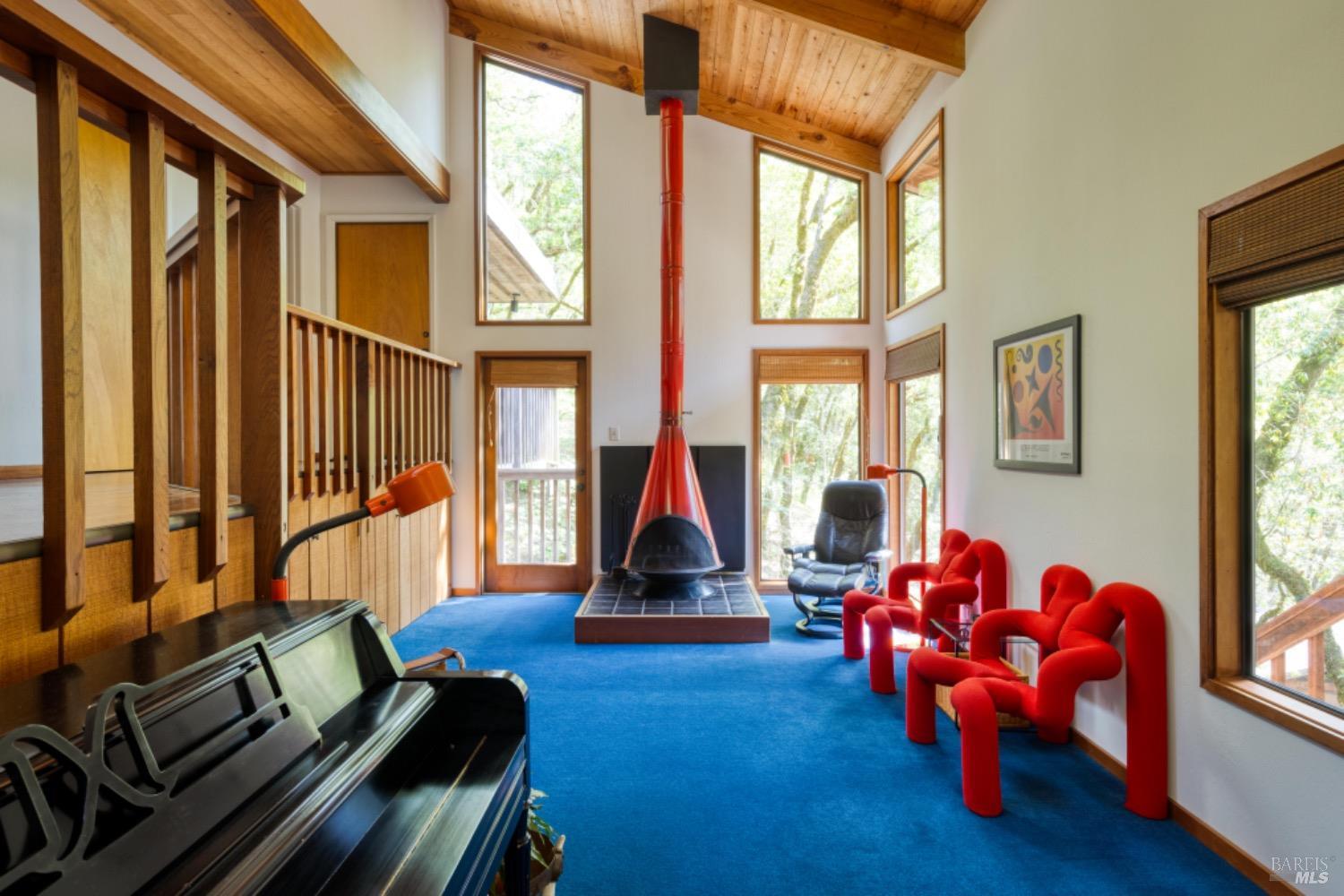 a living room with furniture gym equipment and a window