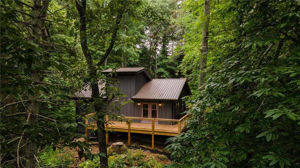 a view of house with a yard and sitting area