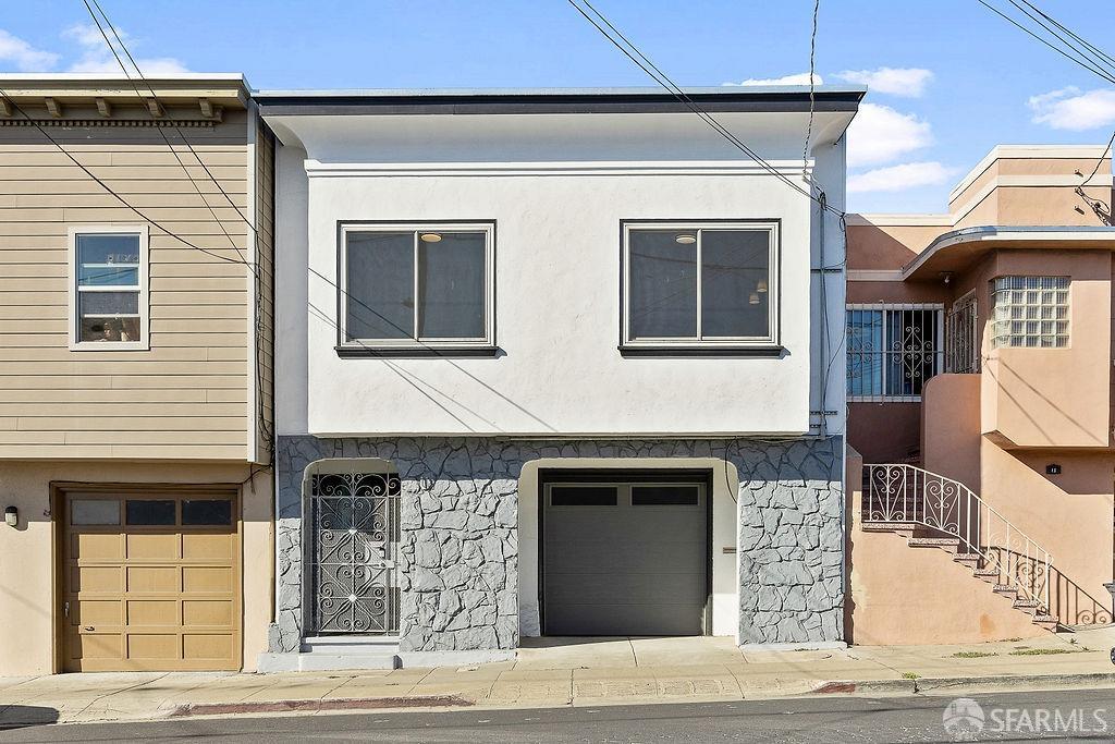 a front view of a house with garage