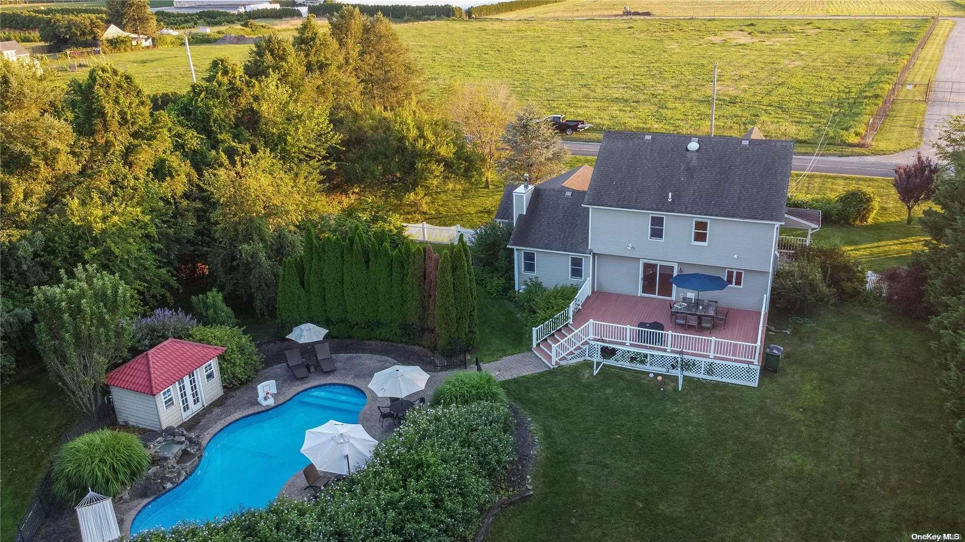 an aerial view of a house with garden space and ocean view