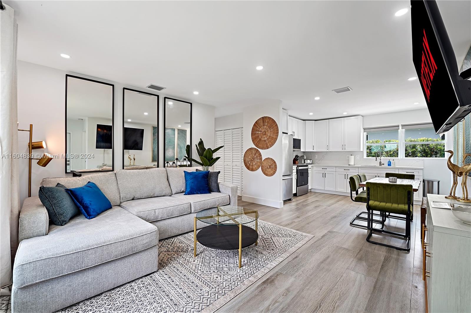 a living room with furniture and a view of kitchen