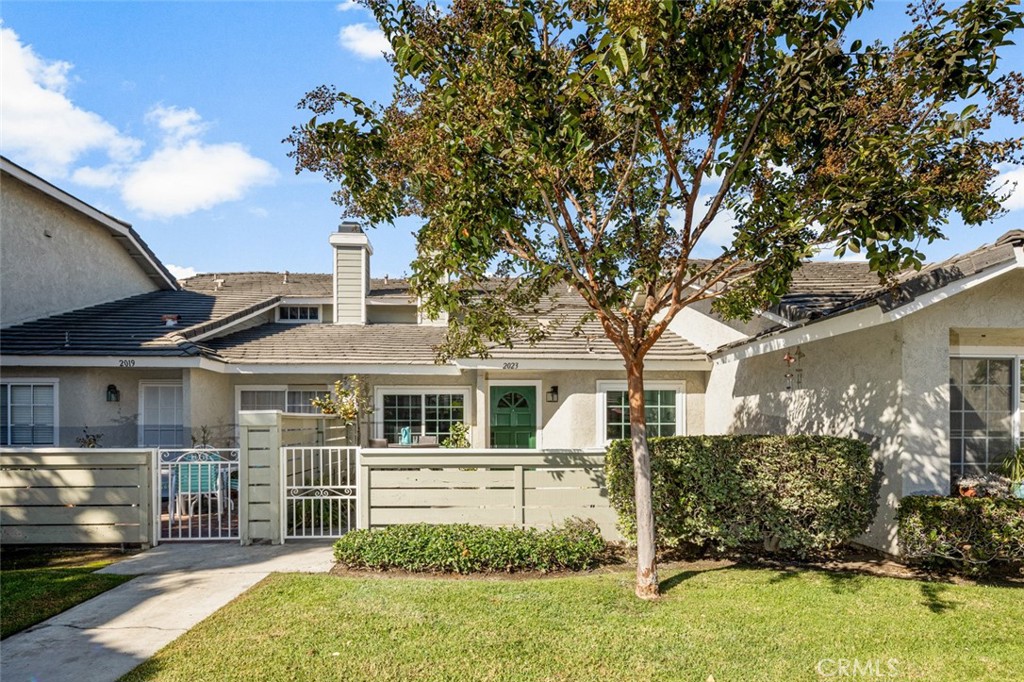 front view of a house with a tree in a yard