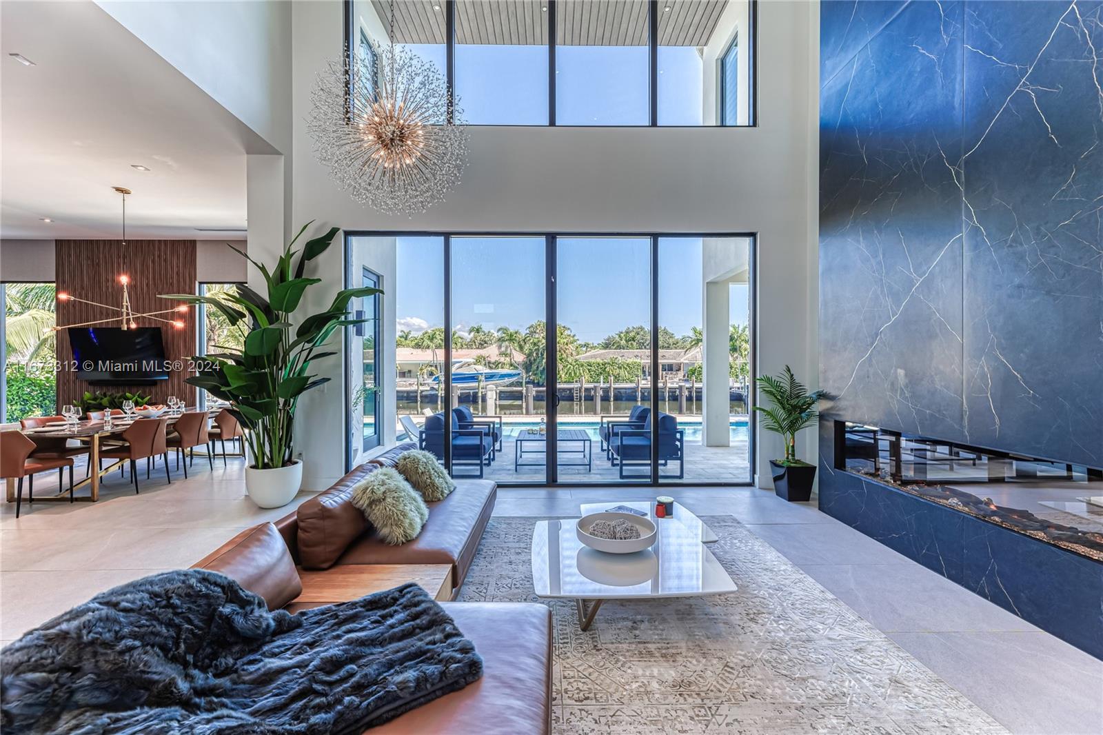 a living room with furniture and a floor to ceiling window