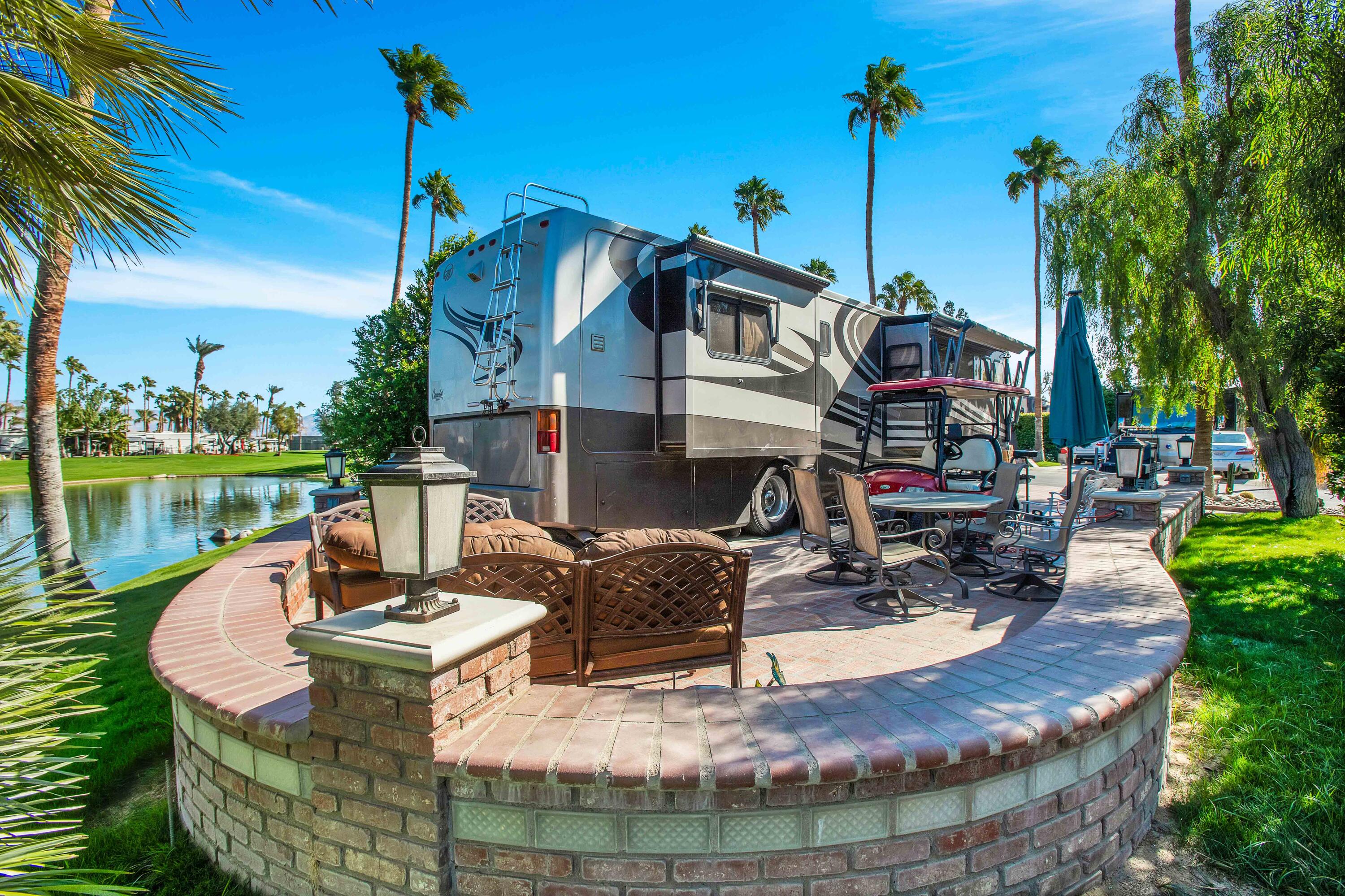 a view of a house with backyard water fountain and sitting area