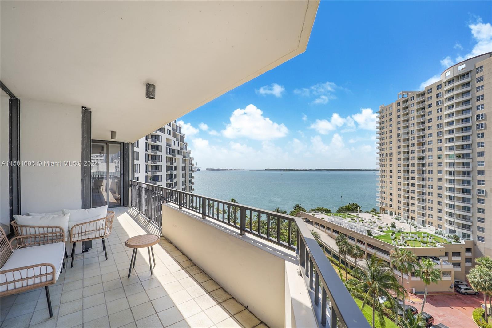 a balcony with chairs and table