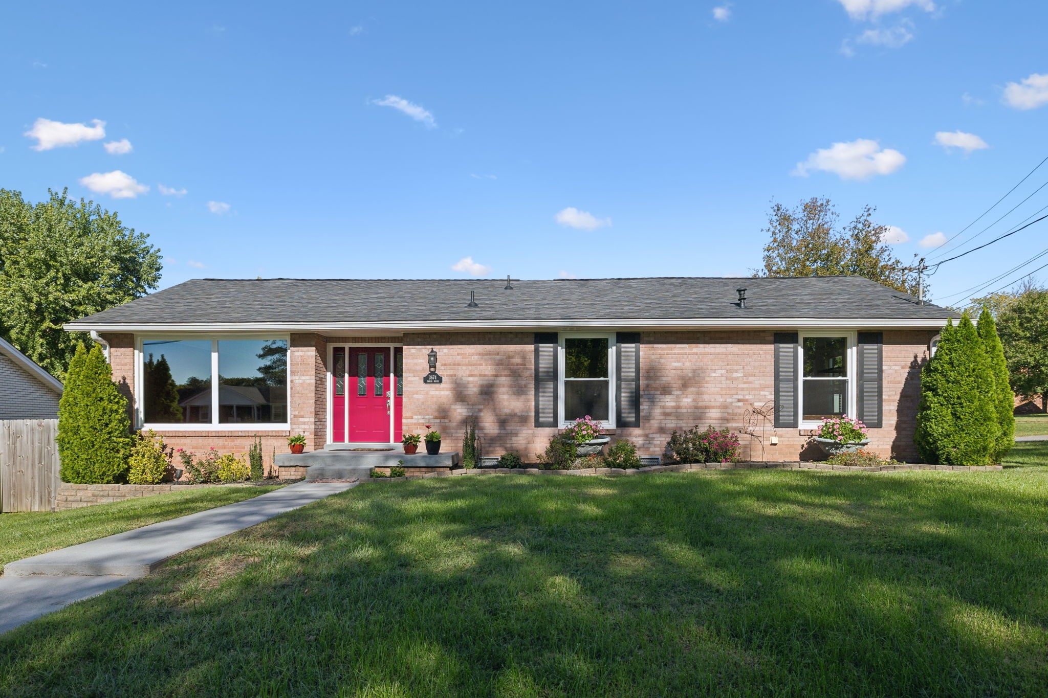 a front view of house with yard and outdoor seating