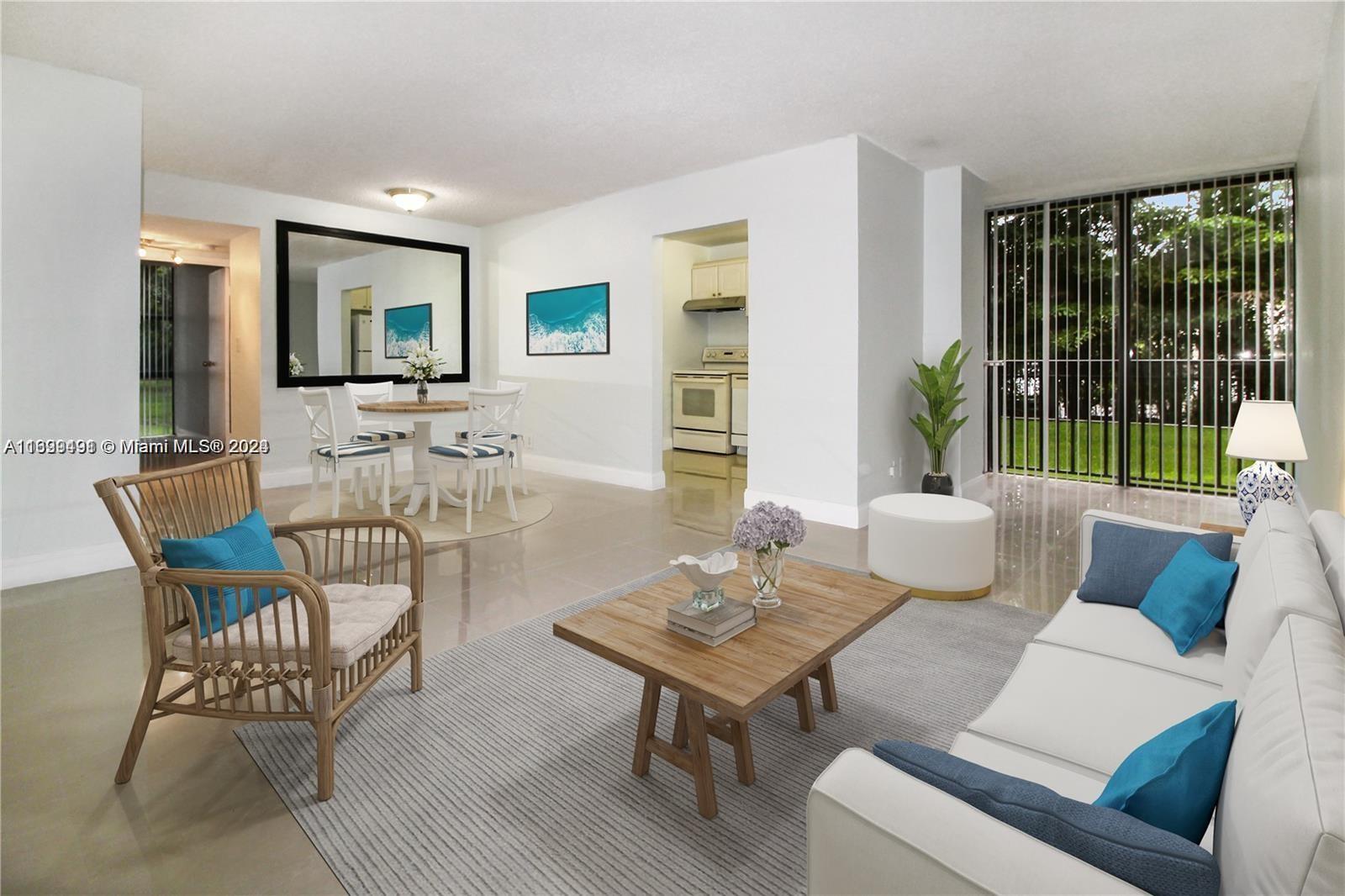 a living room with furniture and a floor to ceiling window