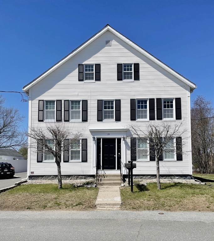 a house that has a tree in front of it