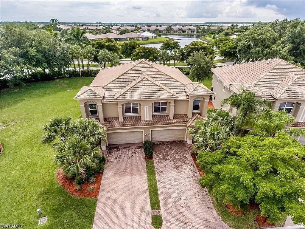 Birds eye view of property with a water view