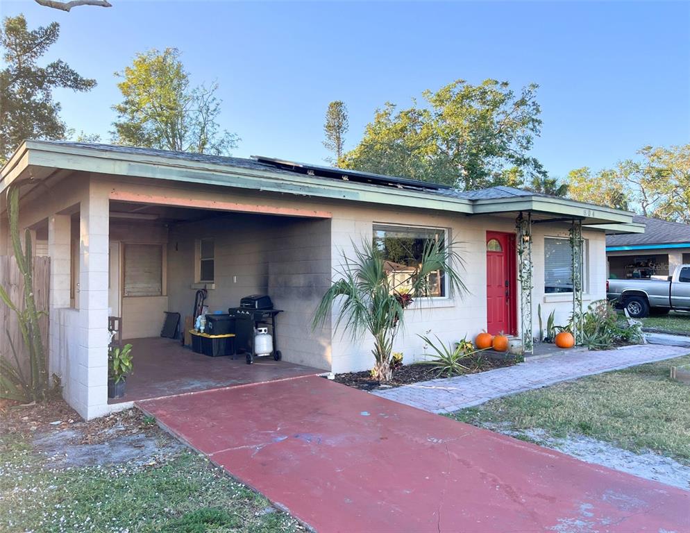 a front view of a house with porch and seating space