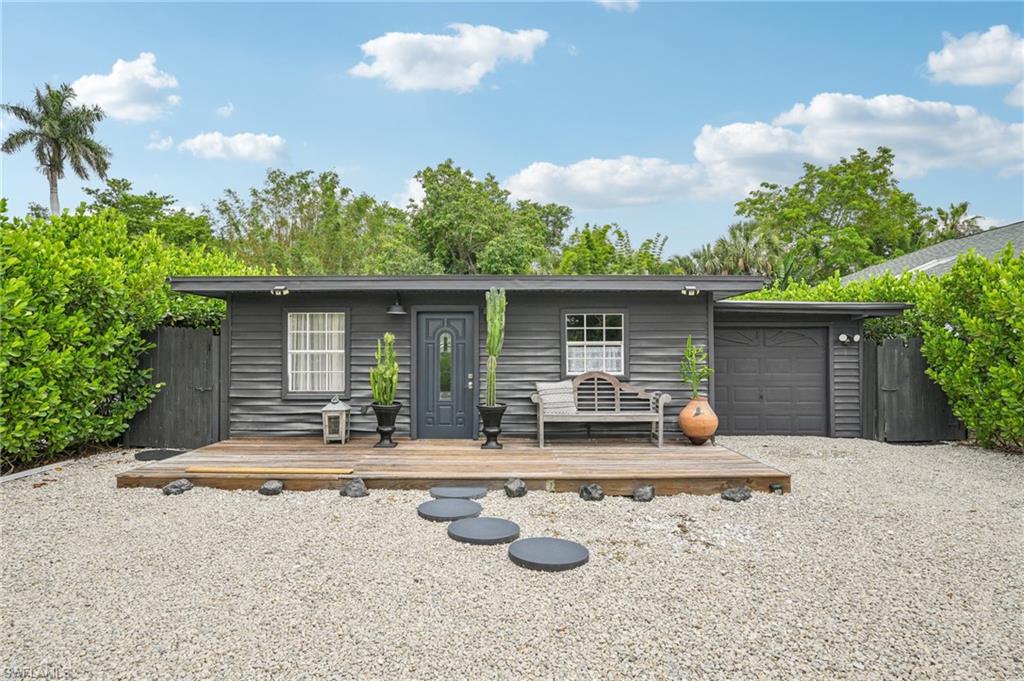 View of front of property with a wooden deck