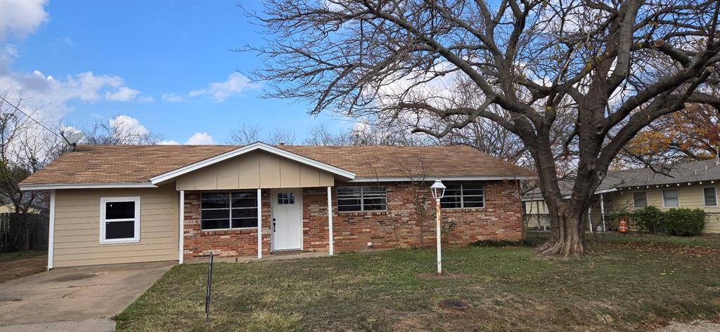 a house that has a tree in front of the house