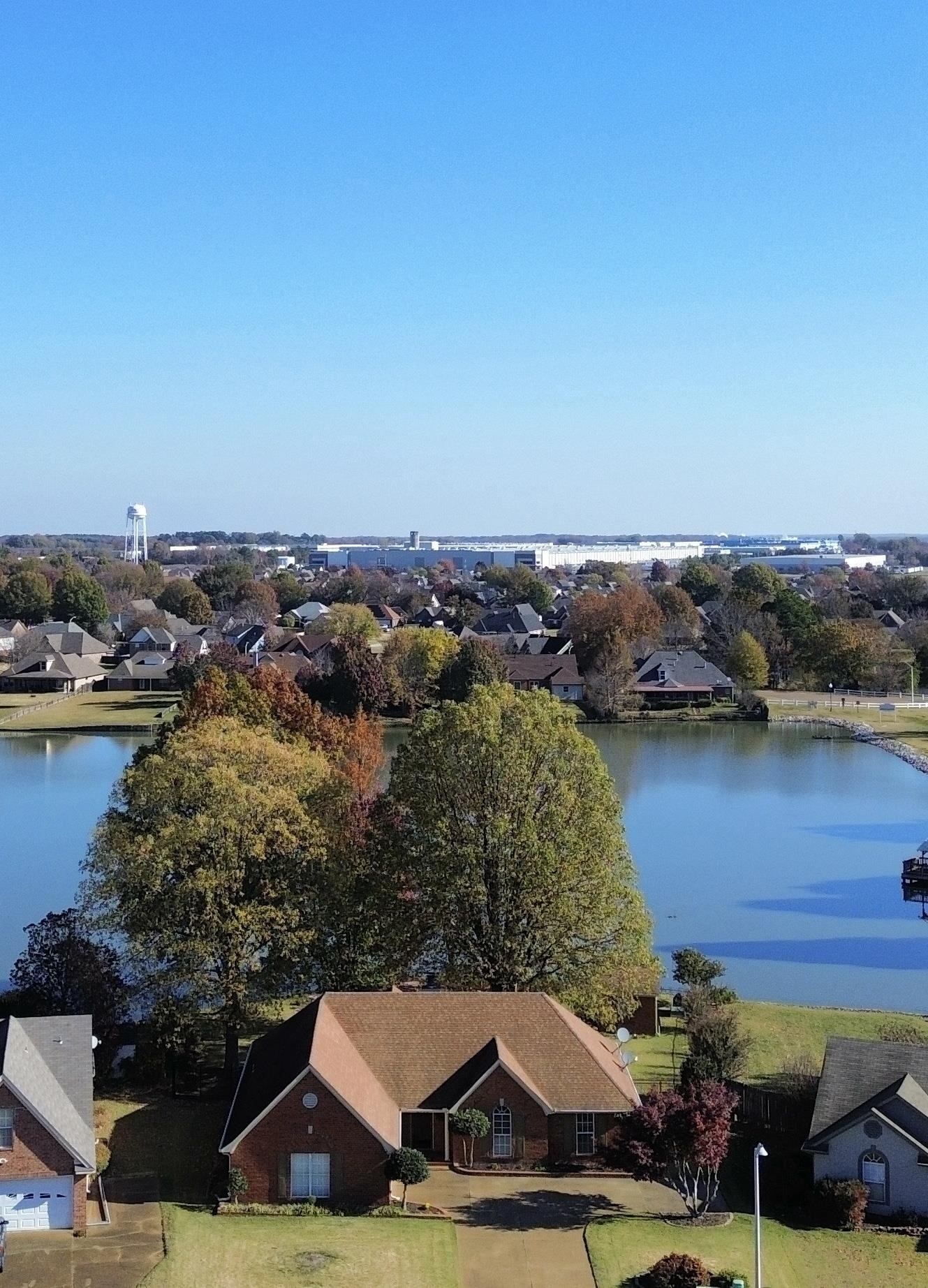 an aerial view of a house with a lake view