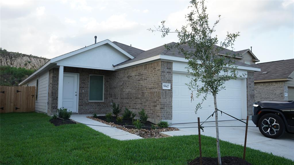 a view of a house with a yard and pathway