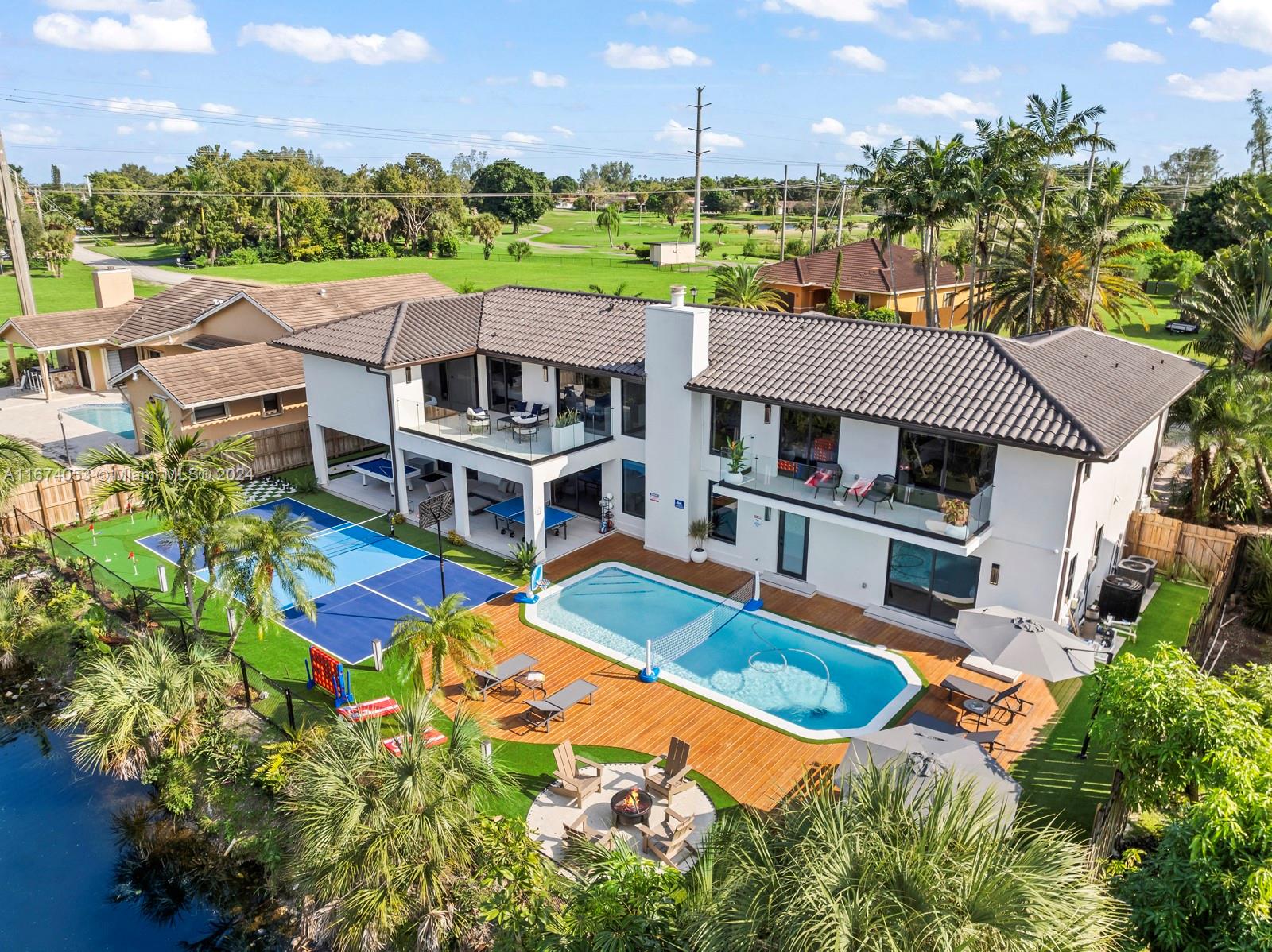 an aerial view of a house with a big yard and potted plants